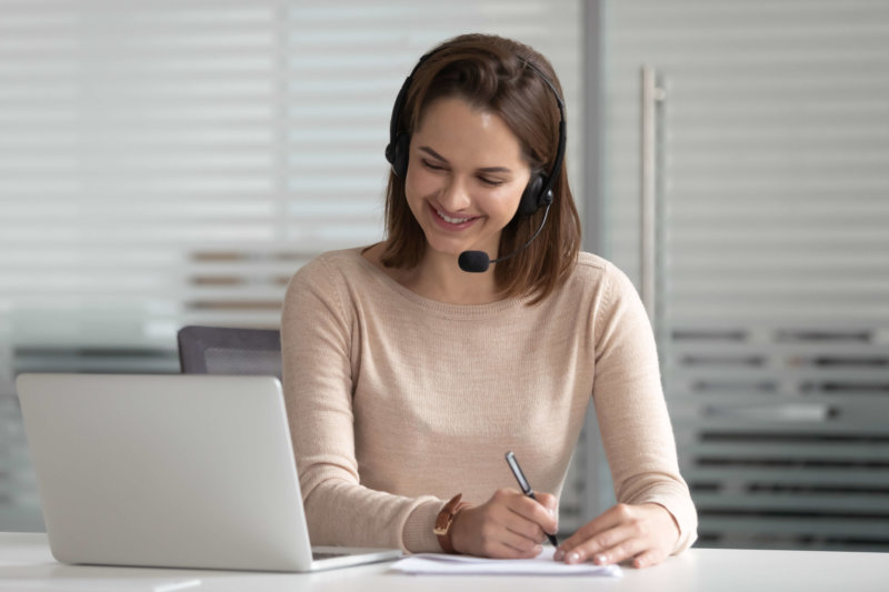 woman customer support service agent using VoIP to conduct call with client
