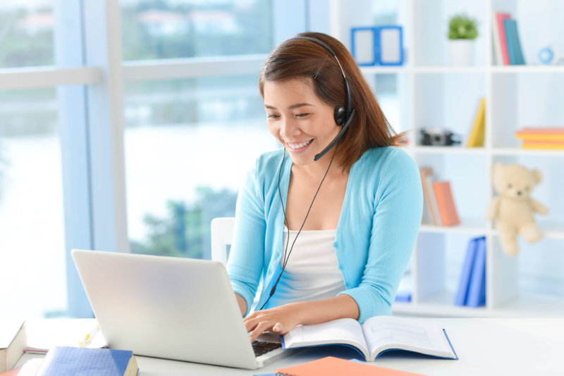 A young woman talking on Skype as VoIP