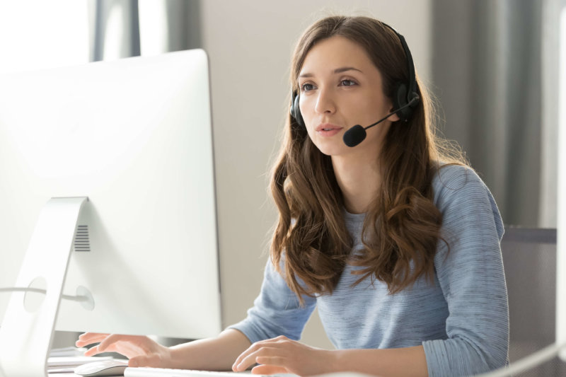 Businesswoman in headset call center agent consulting participating in a call using VoIP