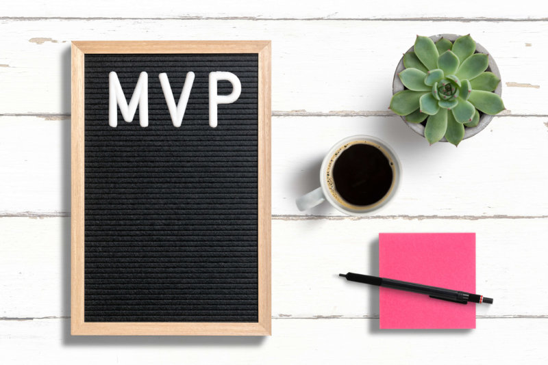 Minimum viable product or MVP written on letter board next to sticky note, coffee and a succulent plant