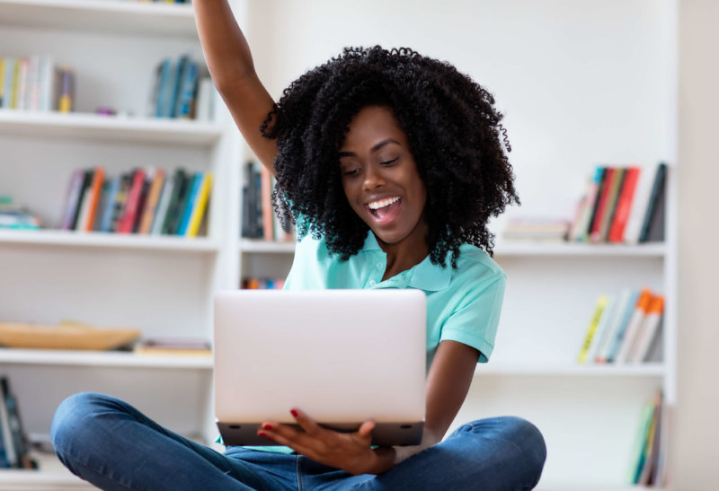 Woman cheering, excited about the best free ecommerce platforms