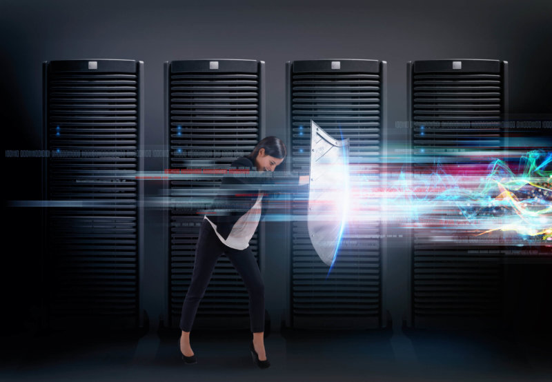 Concept of safety in a data center room with database server. Woman with shield defends against hacker attacks, network firewall security concept