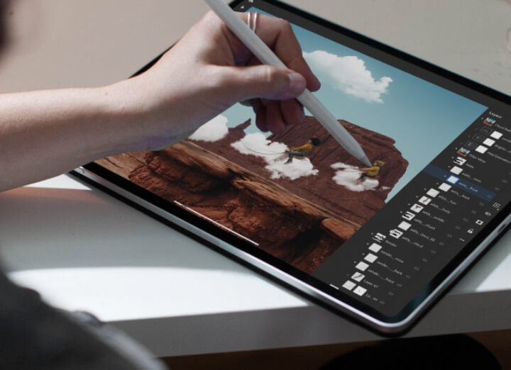 photo of person using Photoshop on a tablet with the help of a stylus